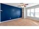 Bedroom featuring a blue accent wall, neutral carpet, and large window at 320 Harden St, Atlanta, GA 30312