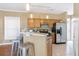 Kitchen with stainless steel refrigerator, tile flooring, and a convenient breakfast bar for casual dining at 320 Harden St, Atlanta, GA 30312