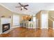 Inviting living room featuring hardwood floors, a cozy fireplace, and an open layout to the kitchen at 320 Harden St, Atlanta, GA 30312