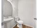 Cozy bathroom with a pedestal sink and a decorative mirror at 36 Crescent, Dallas, GA 30157