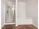 Bathroom featuring a glass-enclosed shower and a separate soaking tub at 36 Crescent, Dallas, GA 30157