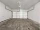 Empty two car garage with concrete floor and white garage door at 36 Crescent, Dallas, GA 30157