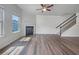 Bright living room featuring hardwood floors, fireplace, and stairs to the second floor at 36 Crescent, Dallas, GA 30157