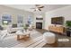 Bright living room with fireplace, hardwood floors, and ample natural light; virtually staged at 36 Crescent, Dallas, GA 30157
