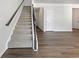 Carpeted staircase with a dark wood banister and access to the upper level at 36 Crescent, Dallas, GA 30157
