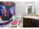 Themed bathroom with shower curtain, sink, toilet, and cabinet at 368 Rankin Cir, Mcdonough, GA 30253