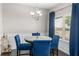 Cozy dining room featuring a round table, blue chairs, stylish lighting, and a window with natural light at 368 Rankin Cir, Mcdonough, GA 30253