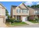 Charming home exterior featuring tan siding, brick accents, and a well-manicured lawn in a friendly neighborhood at 368 Rankin Cir, Mcdonough, GA 30253