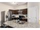 Modern kitchen features stainless steel appliances, granite countertops, and dark wood cabinets at 368 Rankin Cir, Mcdonough, GA 30253