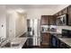 Stylish kitchen with stainless steel refrigerator and range, granite counters, and dark cabinets at 368 Rankin Cir, Mcdonough, GA 30253