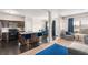 Open living space with modern kitchen island, stylish blue bar stools, and a cozy living room area with comfortable seating at 368 Rankin Cir, Mcdonough, GA 30253