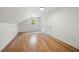 Bright attic room with hardwood floors, window, and white walls perfect for an office or playroom at 3710 Country Estate Dr Nw, Kennesaw, GA 30152