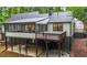 Charming backyard boasts a screened porch, deck, and a lower level patio with swing at 3710 Country Estate Dr Nw, Kennesaw, GA 30152