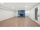 Finished basement with wood flooring, brick fireplace, and walk-out door to the exterior at 3710 Country Estate Dr Nw, Kennesaw, GA 30152