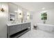 Luxurious bathroom featuring dual sinks, elegant lighting, and a freestanding tub at 3710 Country Estate Dr Nw, Kennesaw, GA 30152