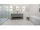 Bright bathroom featuring double vanity, soaking tub, glass shower, and marble tile flooring at 3710 Country Estate Dr Nw, Kennesaw, GA 30152