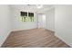Bedroom with wood flooring, white walls, ceiling fan, and natural light from the exterior at 3710 Country Estate Dr Nw, Kennesaw, GA 30152