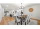 Open dining room features modern chandelier and flows seamlessly into adjacent kitchen at 3710 Country Estate Dr Nw, Kennesaw, GA 30152