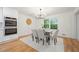 Bright dining room with modern chandelier and large windows overlooking lush backyard at 3710 Country Estate Dr Nw, Kennesaw, GA 30152