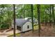 Exterior view of home with garage surrounded by lush greenery and a wooded landscape at 3710 Country Estate Dr Nw, Kennesaw, GA 30152