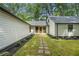Inviting home exterior with a stone pathway and lush landscaping leading to the front entrance at 3710 Country Estate Dr Nw, Kennesaw, GA 30152