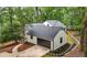 View of attached garage of a home with dark brown garage door and manicured landscaping at 3710 Country Estate Dr Nw, Kennesaw, GA 30152