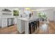 Modern, eat-in kitchen with stainless steel appliances, white cabinets, and hardwood flooring at 3710 Country Estate Dr Nw, Kennesaw, GA 30152