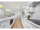 Bright, open kitchen featuring stainless steel appliances, white cabinets and hardwood flooring at 3710 Country Estate Dr Nw, Kennesaw, GA 30152