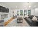 Bright living room features a stone fireplace, hardwood floors, and ample natural light at 3710 Country Estate Dr Nw, Kennesaw, GA 30152