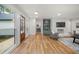 Open-concept living room with hardwood floors and a decorative stone fireplace at 3710 Country Estate Dr Nw, Kennesaw, GA 30152