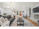 Spacious living room with stone fireplace, modern lighting, and hardwood flooring at 3710 Country Estate Dr Nw, Kennesaw, GA 30152