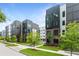 Modern townhome exteriors feature brick and dark siding, complemented by lush green landscaping at 388 Pratt Dr # 2113, Atlanta, GA 30315