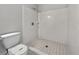 Bathroom featuring a tiled shower, toilet, and tile flooring at 256 Prometheous Way, Rockmart, GA 30153