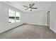 Bright bedroom featuring neutral carpet, a ceiling fan, and a large window at 256 Prometheous Way, Rockmart, GA 30153