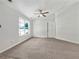 Clean, empty bedroom with plush carpet, ceiling fan, and bright natural light from large windows at 256 Prometheous Way, Rockmart, GA 30153