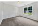 Simple bedroom with plush carpet, ceiling fan, and bright natural light from large windows at 256 Prometheous Way, Rockmart, GA 30153