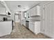 Well-lit kitchen featuring white cabinets, stainless steel appliances, and neutral flooring at 256 Prometheous Way, Rockmart, GA 30153