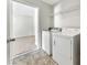 Convenient laundry room featuring a washer, dryer, and shelving for storage at 256 Prometheous Way, Rockmart, GA 30153