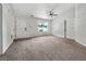 Bright living room featuring neutral carpet, a ceiling fan, and a window with a view at 256 Prometheous Way, Rockmart, GA 30153