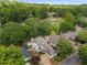 Aerial view of a home nestled in a lush, tree-filled neighborhood next to a golf course at 2610 Links End, Roswell, GA 30076