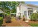 Well-maintained backyard features mature landscaping, dining area, pergola, and gated garden at 2610 Links End, Roswell, GA 30076