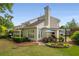 Expansive backyard features lush green lawn, mature trees, and covered outdoor dining area at 2610 Links End, Roswell, GA 30076