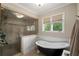 Inviting bathroom features a soaking tub, walk-in shower, and large window at 2610 Links End, Roswell, GA 30076