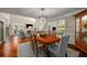 Well-lit dining room featuring a chandelier, hardwood floors, and access to outdoor spaces at 2610 Links End, Roswell, GA 30076