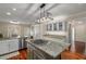 Well-equipped kitchen features an island cooktop, granite counters, and classic white cabinetry at 2610 Links End, Roswell, GA 30076