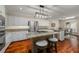 Modern kitchen featuring stainless steel appliances, an island with seating, and wood flooring at 2610 Links End, Roswell, GA 30076
