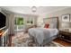Comfortable main bedroom with balcony access, neutral colors, and hardwood floors at 2610 Links End, Roswell, GA 30076