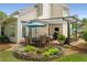 Relaxing patio with dining and seating area, covered pergola, and meticulously manicured landscaping at 2610 Links End, Roswell, GA 30076