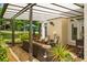 Covered outdoor living space features comfortable seating, ceiling fan, and views of the landscaped yard at 2610 Links End, Roswell, GA 30076