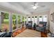 Bright sunroom with large windows, hardwood floors, and comfortable seating, perfect for relaxation at 2610 Links End, Roswell, GA 30076